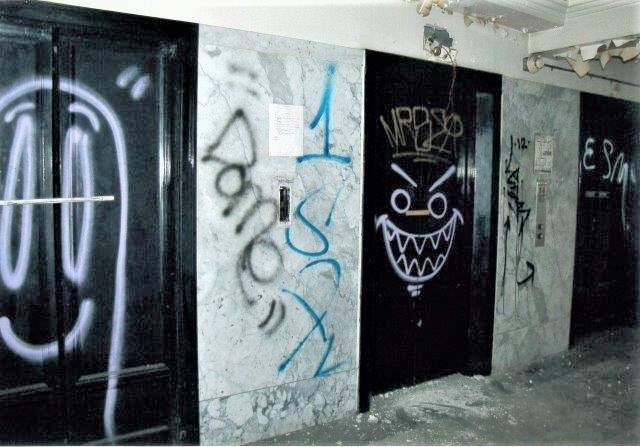 Before: residential lobby elevators with graffiti